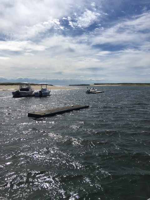 Moored boats and the sandy entry to Pamet Harbor