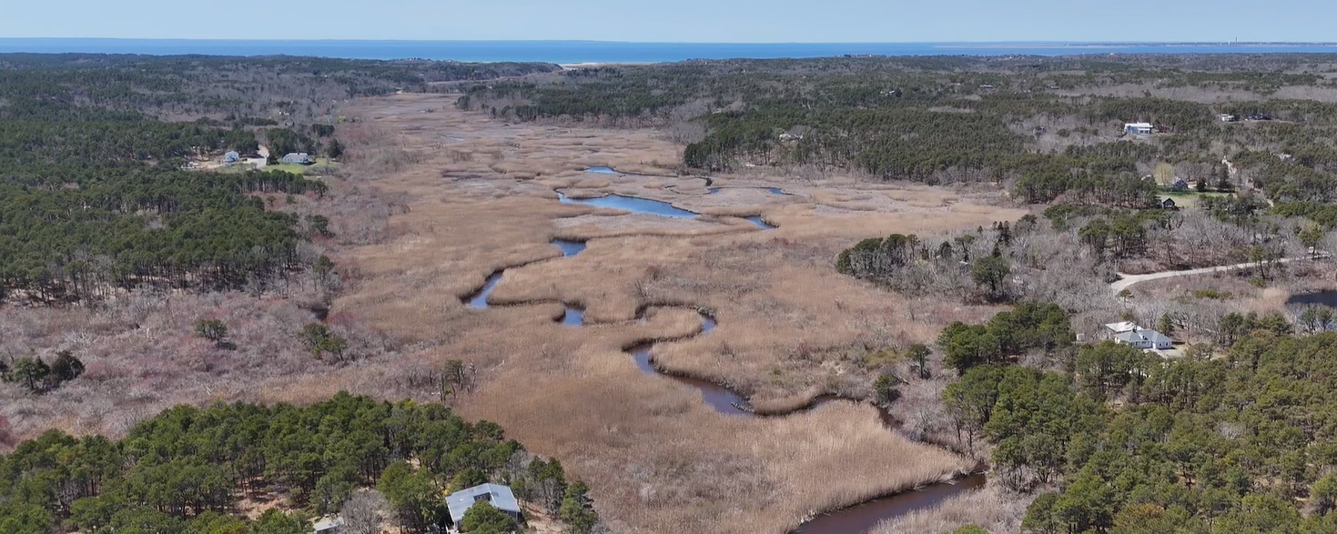 Aerial view of the upper Pamet River winding through the marsh toward Cape Cod Bay